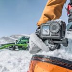 An action shot featuring the Kaiser Baas X450 which is the best budget action camera in a snowy environment, highlighting its ruggedness and capability to record in extreme conditions without the high expense.