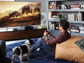 A gamer enjoys an immersive racing game on a large-screen TV, touted as one of the best gaming TVs for its vivid display and rapid response time, enhancing the at-home gaming experience.