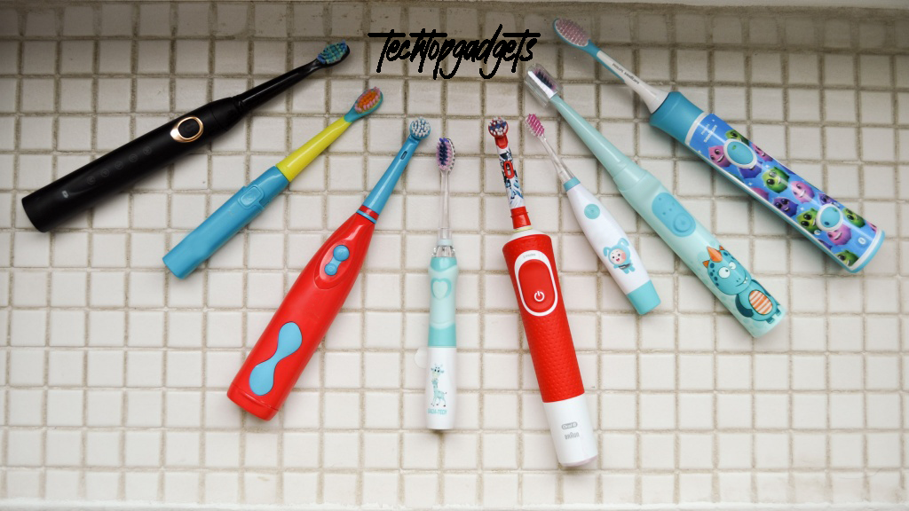 An array of colorful electric toothbrushes for kids laid out against a tiled backdrop, each designed to appeal to young users with bright colors and fun characters, highlighting TechTop's commitment to making the best electric toothbrushes for kids that combine fun and function.