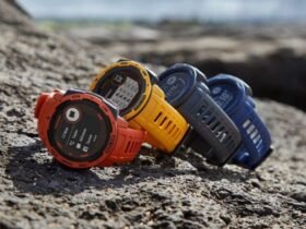 An array of Garmin watches in orange, yellow, blue, and gray, perfectly positioned on rocky terrain, highlighting the best Garmin watch selections for every lifestyle.
