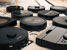 A collection of various robot vacuums on a carpet, showcasing different models and brands, each competing for the title of the best robot vacuum, reflecting the latest in home cleaning technology.