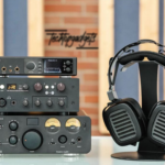A high-end audio setup featuring some of the best headphone amplifiers on the market, including a prominent pair of headphones for an immersive listening experience.