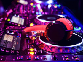 A pair of high-quality headphones resting on a sound mixing console, illustrating the essential tools for DJs and audio engineers.