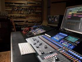 A professional home studio setup showcasing a detailed mixer at the forefront, with colorful, labeled buttons and sliders indicating its advanced functionality, suitable for creating the best music mixes.