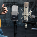 An acoustic guitar recording session using a variety of microphones, including some of the best mics for acoustic guitars, to capture the rich and nuanced sound.