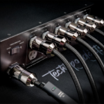 Premium cables connected to the best power conditioner for audio, showcasing advanced power technology for unmatched sound fidelity and protection.