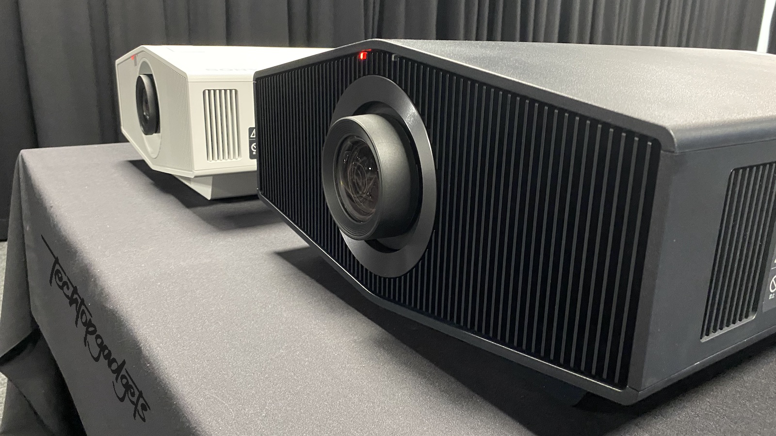 Two top-tier 4K projectors, exemplifying the best 4K projector under 2000, showcased side by side on a display table.
