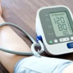 An image depicting a blood pressure monitor in use, displaying clear readings of 120 systolic and 80 diastolic, which are ideal values. The cuff is comfortably wrapped around a large arm, illustrating the device's suitability for individuals with larger arm circumferences.