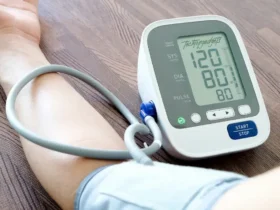An image depicting a blood pressure monitor in use, displaying clear readings of 120 systolic and 80 diastolic, which are ideal values. The cuff is comfortably wrapped around a large arm, illustrating the device's suitability for individuals with larger arm circumferences.