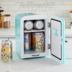 A charming, pastel blue mini fridge, door ajar, displaying an array of LaCroix cans, offers the best freezerless experience for keeping drinks chilled on a kitchen countertop.
