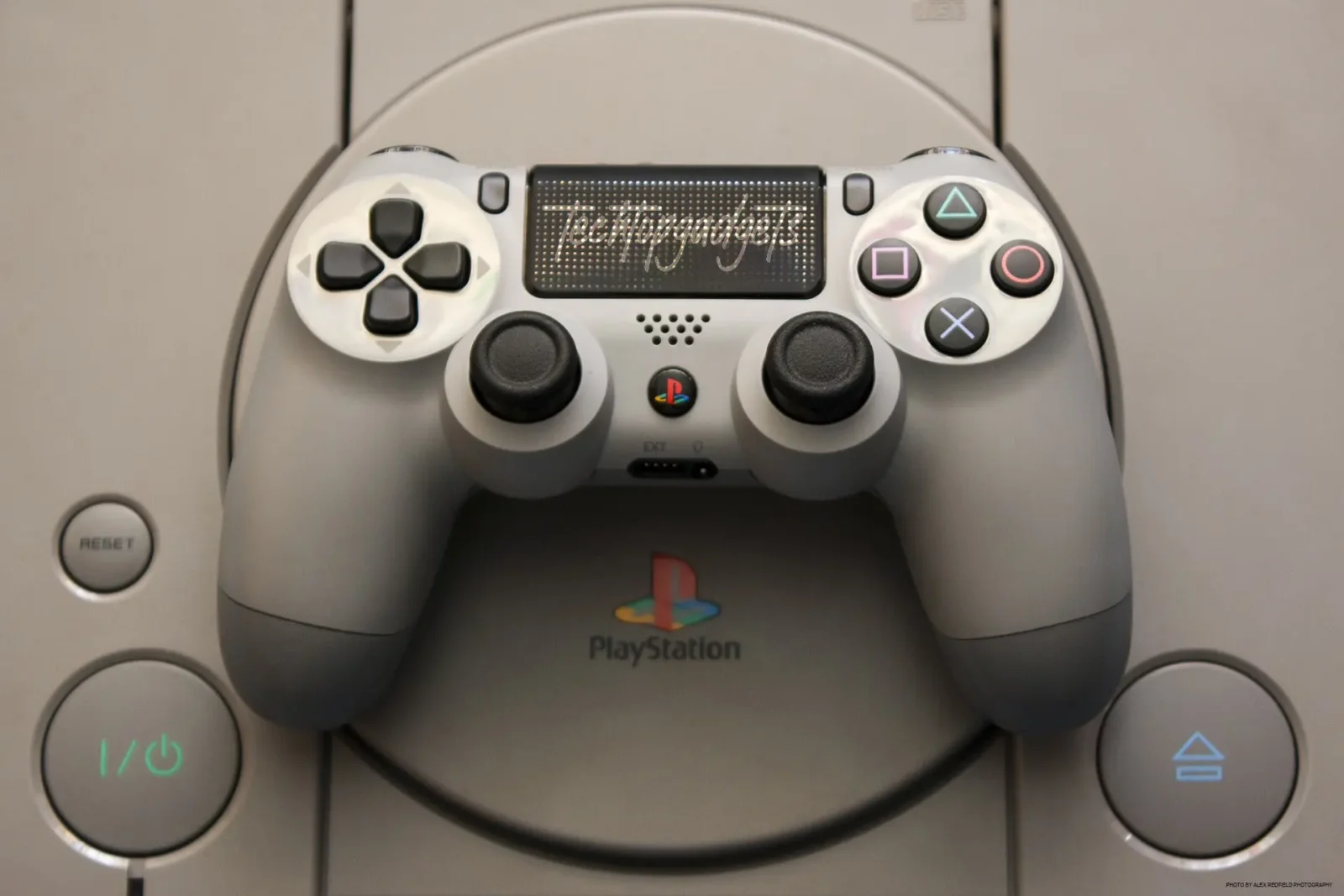Close-up of a PlayStation controller resting on the console, highlighting its ergonomic design and user-friendly buttons, perfect as part of the best gaming console for beginners.