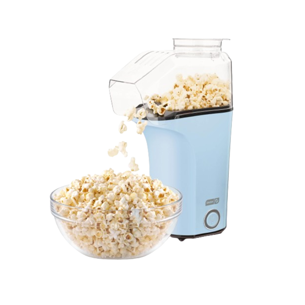 The Dash hot air popcorn maker in pastel blue gently fills a bowl with popped kernels, offering a modern design and quick snack solution for the best air popcorn experience.