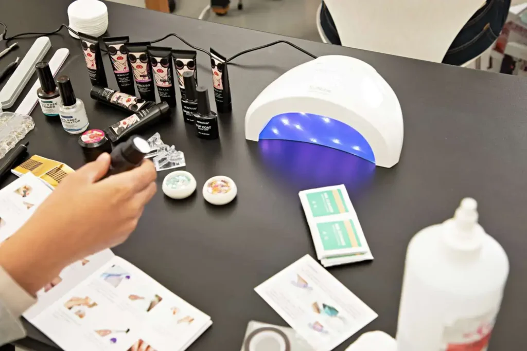 A well-equipped nail art station featuring a white LED nail dryer among various nail art supplies, emphasizing the efficiency of LED nail dryers in creative manicure processes.