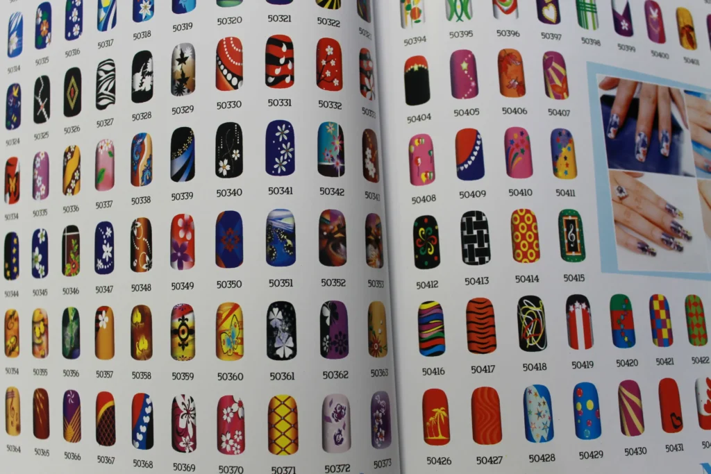 Pages from a catalog displaying an extensive range of nail art designs, signifying the limitless options available through a nail art design printer.