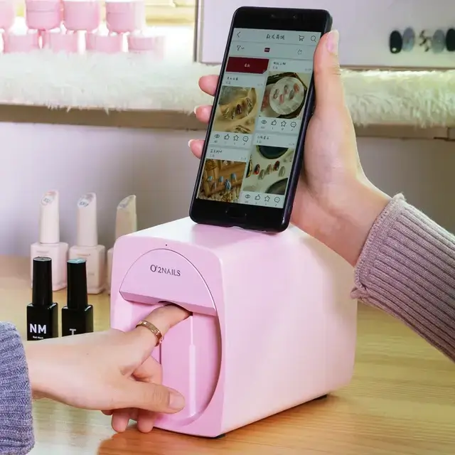 A person selects a nail design on their smartphone linked to a digital nail art printer, representing the forefront of cosmetic technology with an undercurrent of health considerations, such as cancer risks from frequent use.