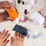 Several individuals engaged in a nail art session with multiple LED nail dryers in use, demonstrating the LED technology's role in enhancing the manicure experience.